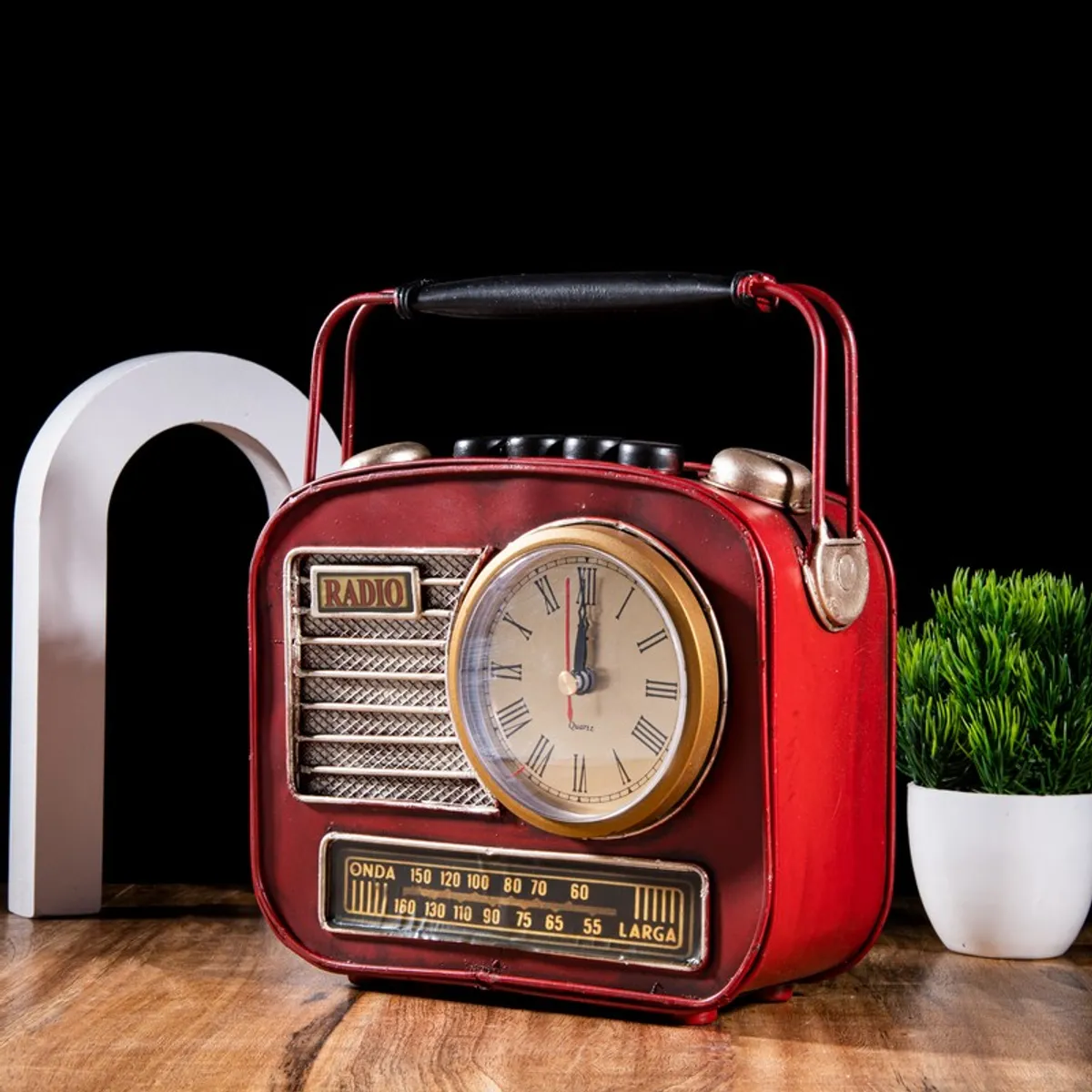 Front view of red vintage radio-inspired showpiece with clock and top handle