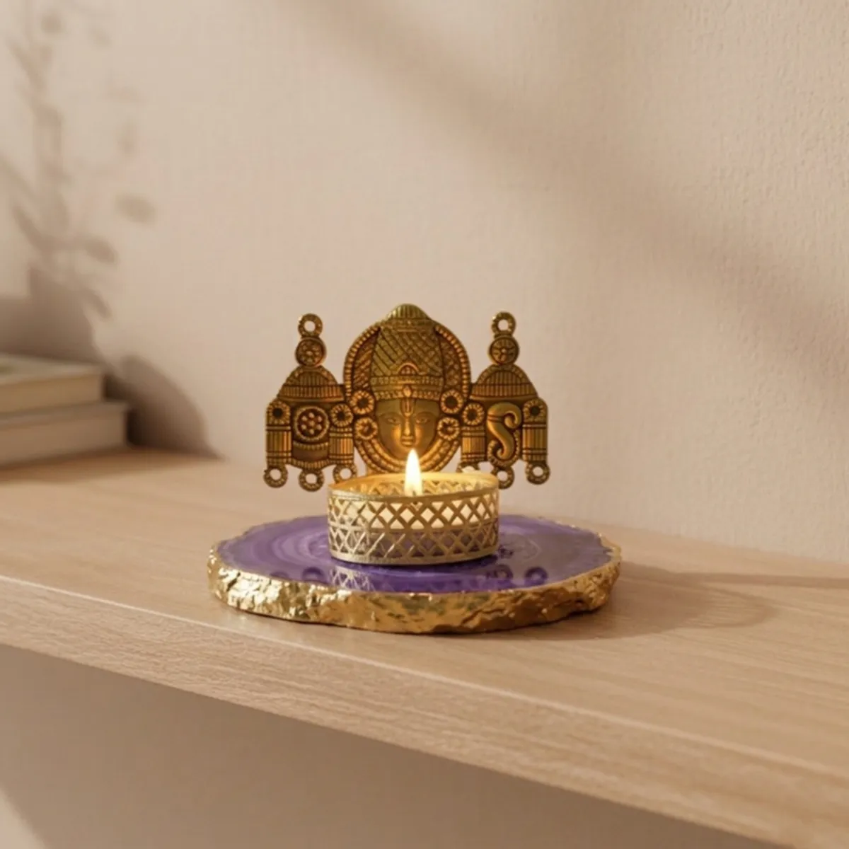 Purple and gold agate tea light holder displayed on a light wood shelf