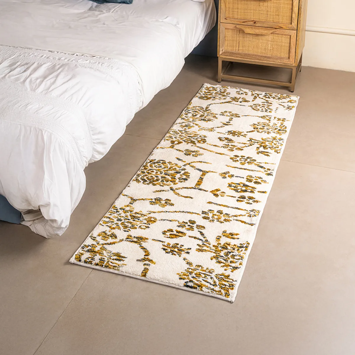 Ivory floral runner placed beside a bed in a bedroom