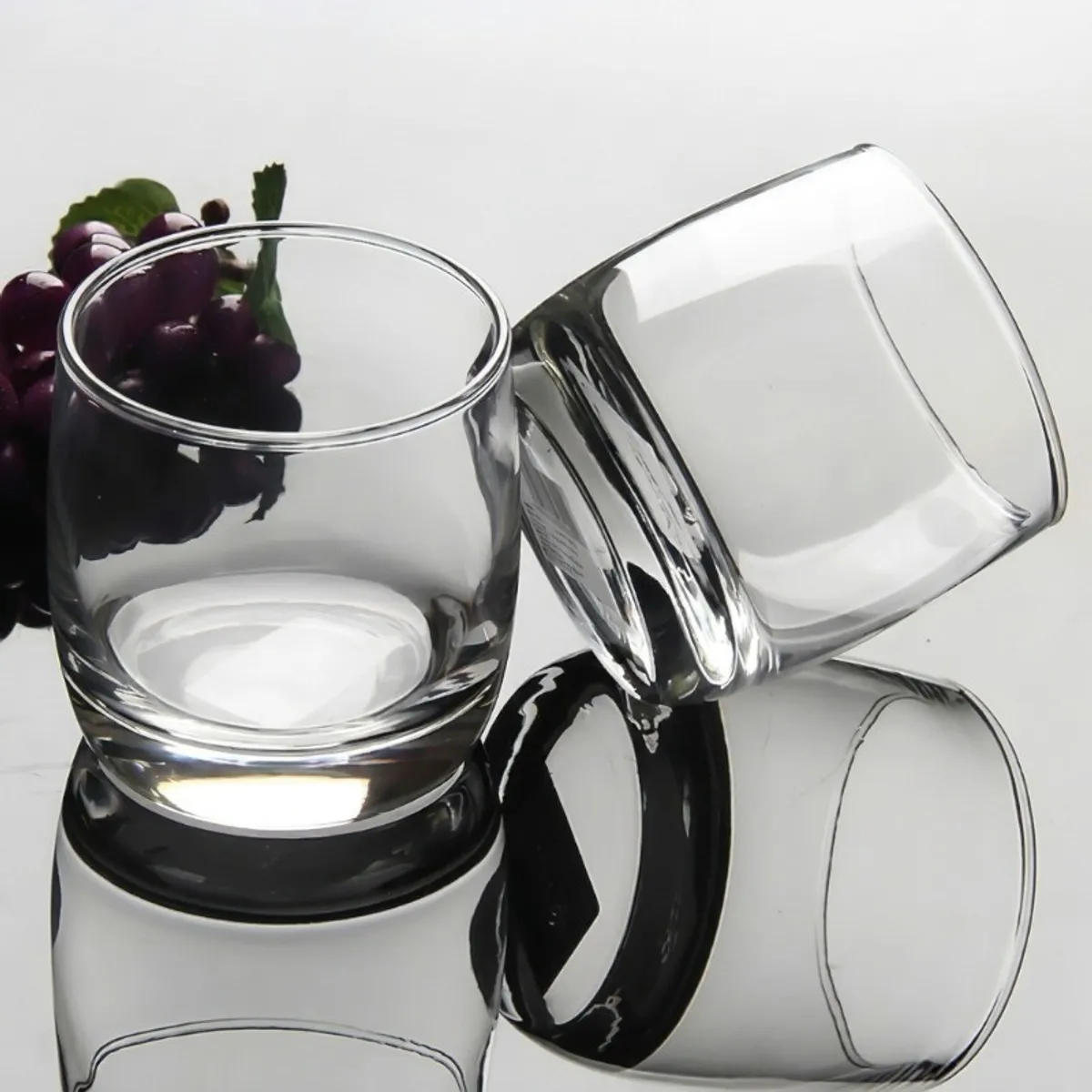 Transparent glasses arranged together against a reflective surface