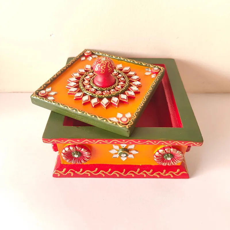 Square decorative storage box shown with lid slightly open