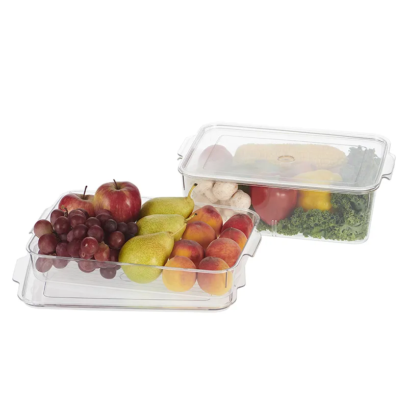Two clear organisers filled with fruit and vegetables against a white background.
