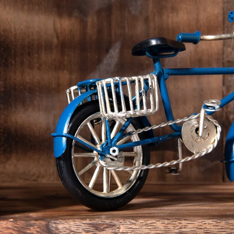 Close-up of rear wheel and basket on dark blue bicycle showpiece