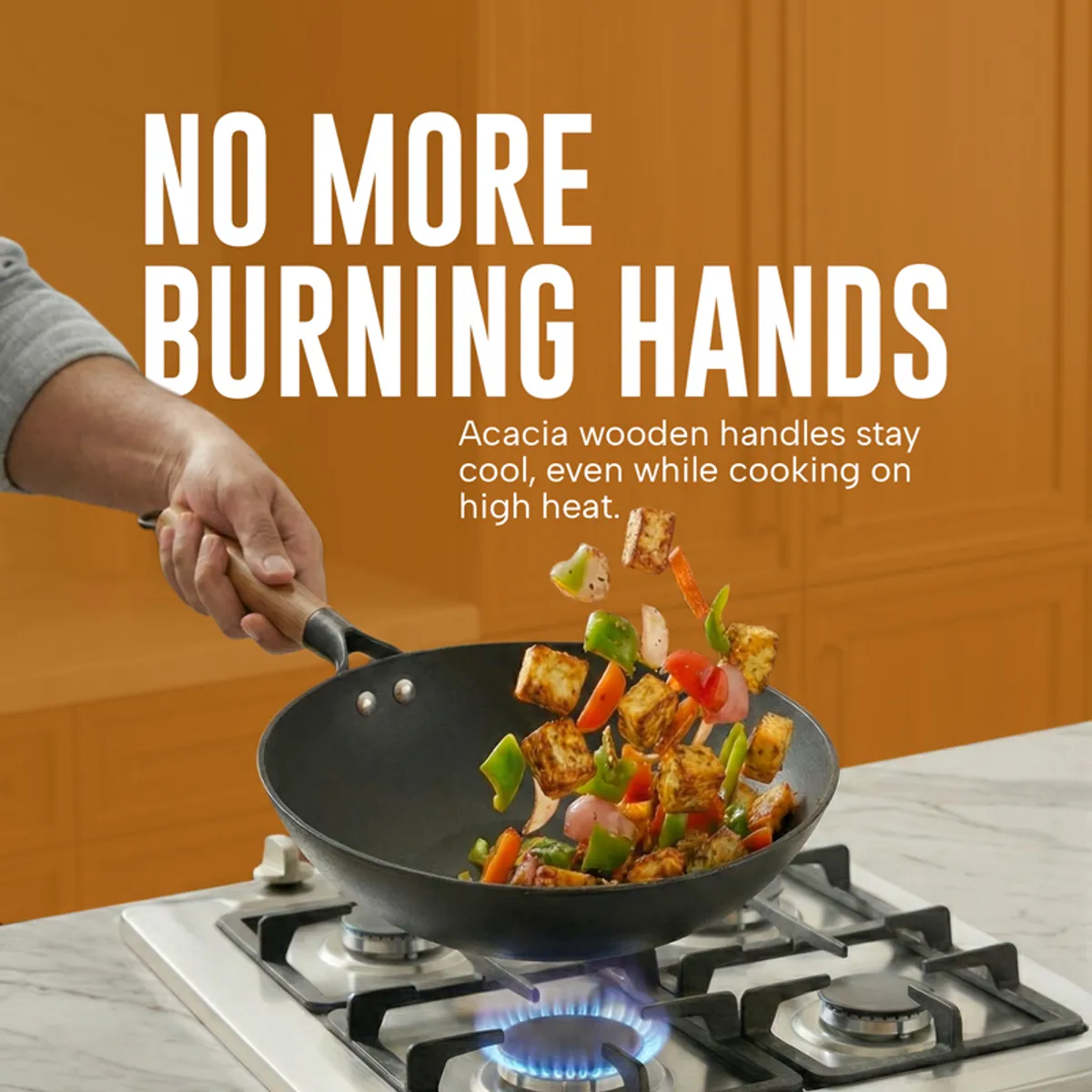 Black frying pan with a wooden handle used for tossing vegetables