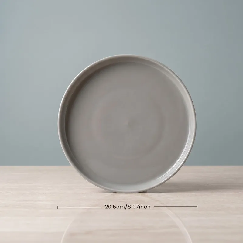 Front view of a grey round quarter plate on a tabletop