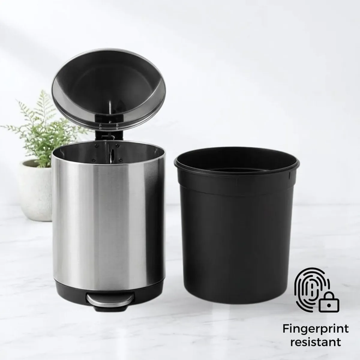 Silver metal dustbin with open lid beside removable black inner bucket