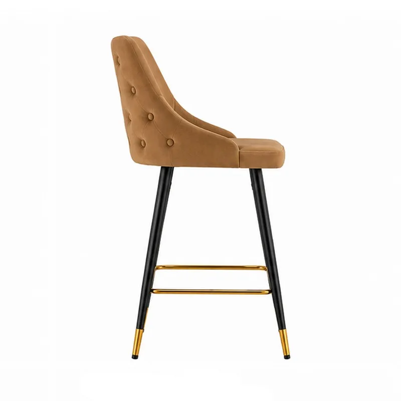 Side view of a brown bar chair with button-tufted back and gold-toned footrest