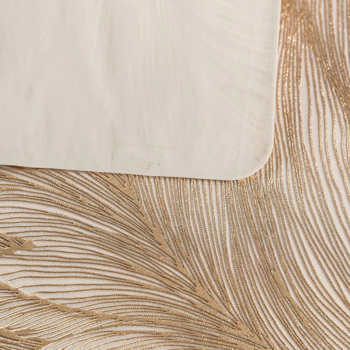 Close-up of the textured feather pattern on a rectangular table mat