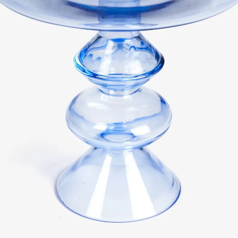 Close-up of the sculptural pedestal base in blue glass