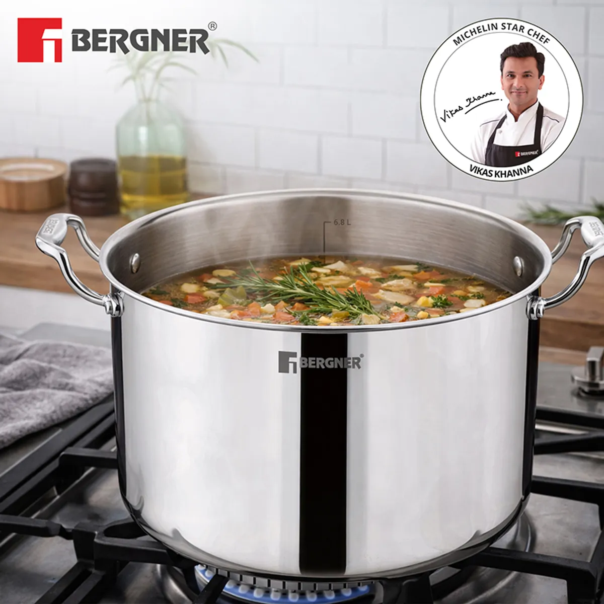 Silver cooking pot filled with soup on a gas stove