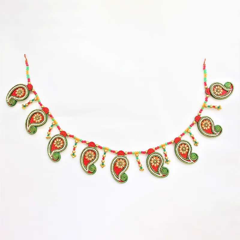 Full view of red beaded toran with hanging decorative motifs