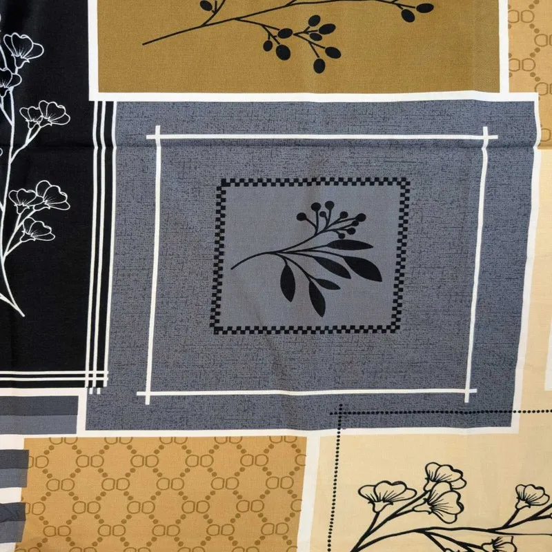 Detailed view of the patchwork-style geometric and botanical print