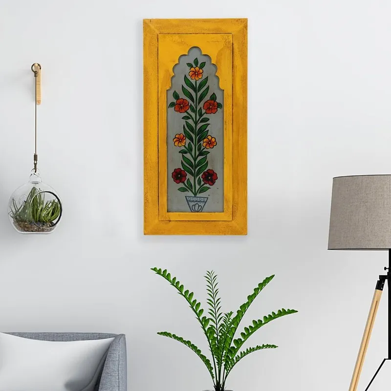 Yellow floral wall accent displayed on a white wall in a living room setting