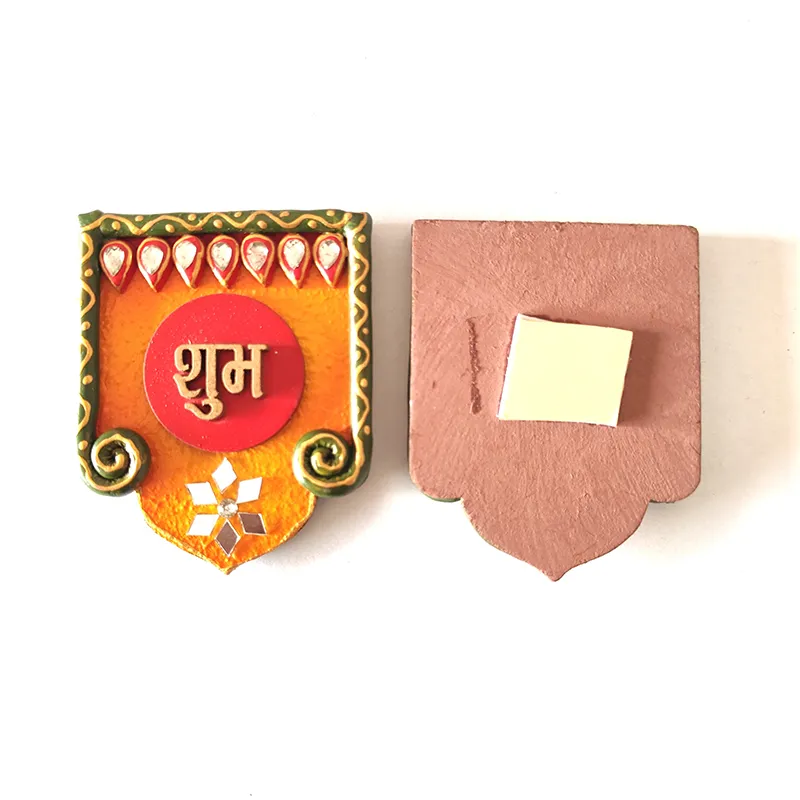 Front and back view of one Shubh wall accent with adhesive pad