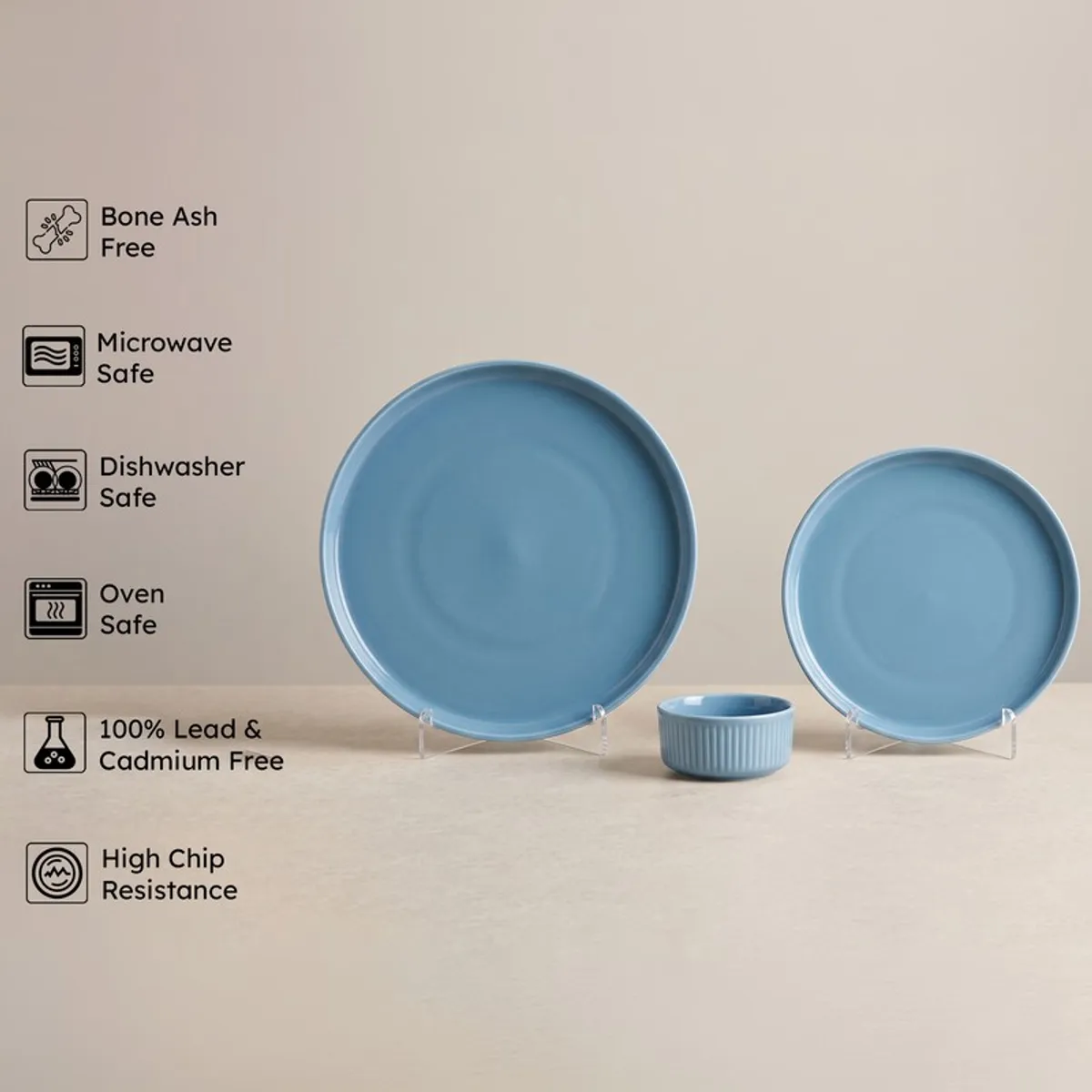 Blue round dinner plate, side plate and ribbed bowl with feature icons beside them
