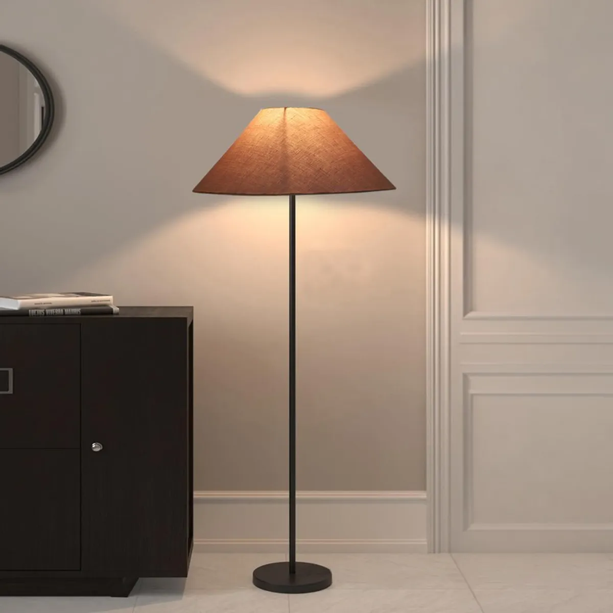 Lit floor lamp with cone shade next to a dark cabinet against a neutral wall