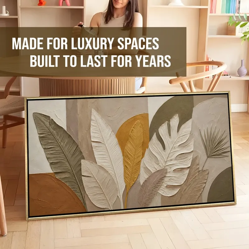 Framed leafscape canvas painting in earthy neutrals leaning against a wall