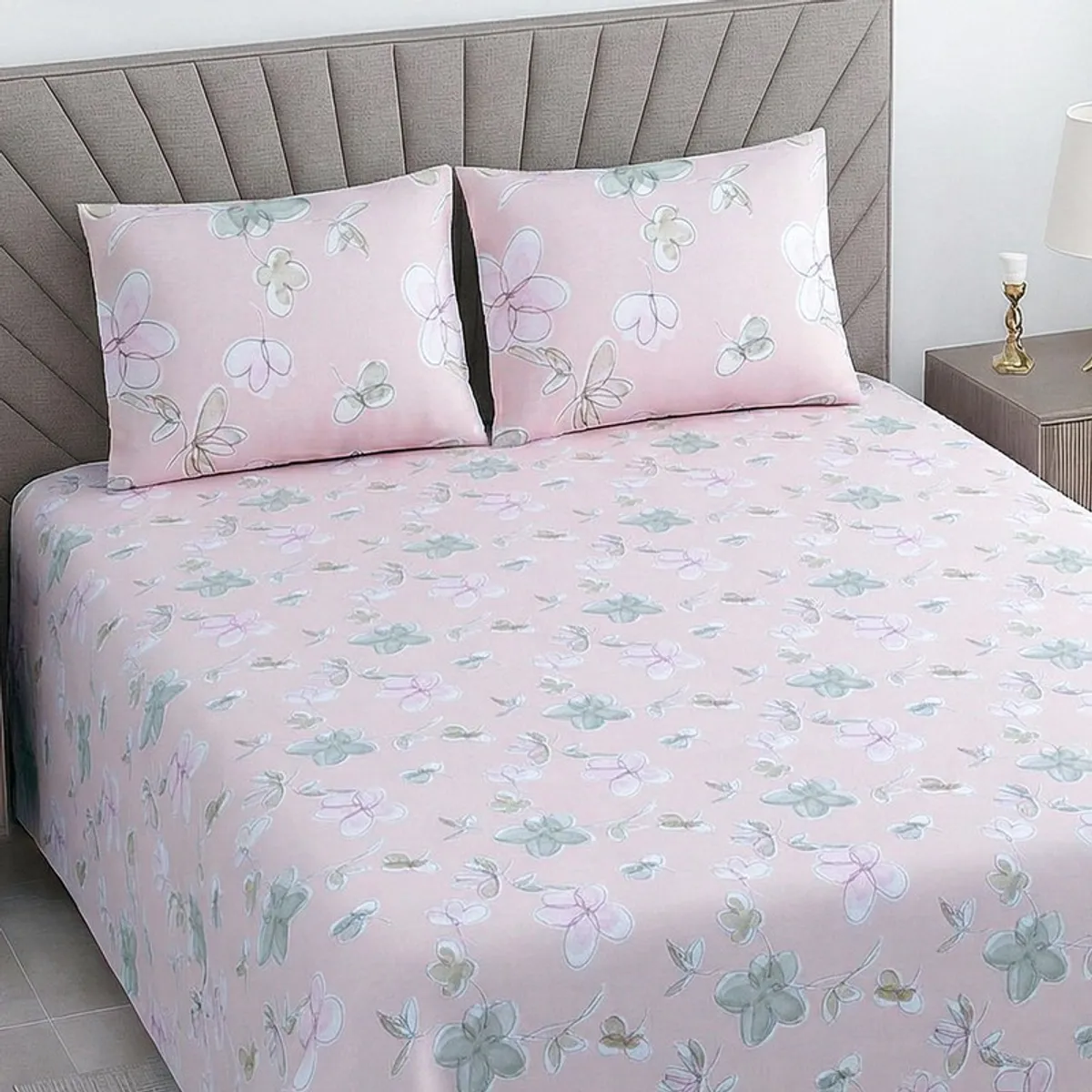 Close view of pink bedsheet with soft floral and botanical print