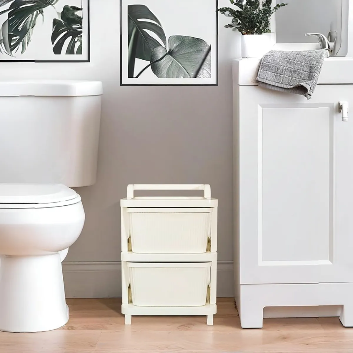White two-tier storage rack placed beside a bathroom vanity