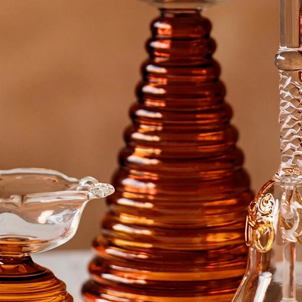 Close-up of the brown ribbed glass diya and transparent glass bell