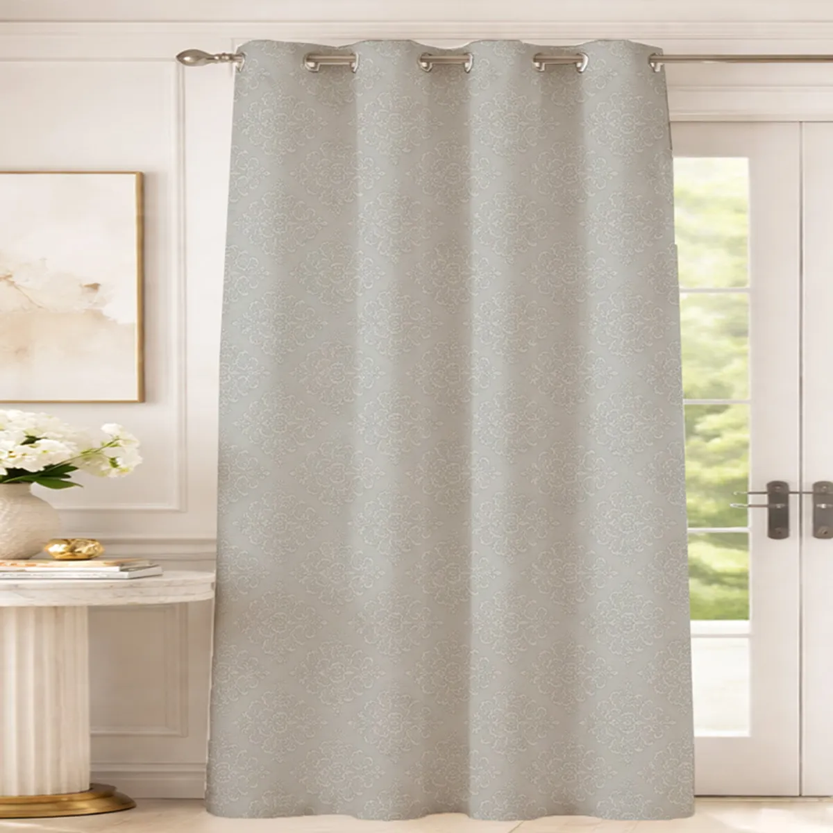 Grey eyelet curtain with subtle damask floral pattern hanging over a door