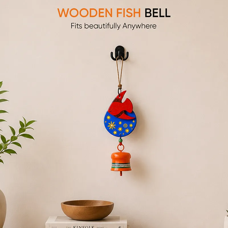 Fish windchime displayed on a wall above a console surface