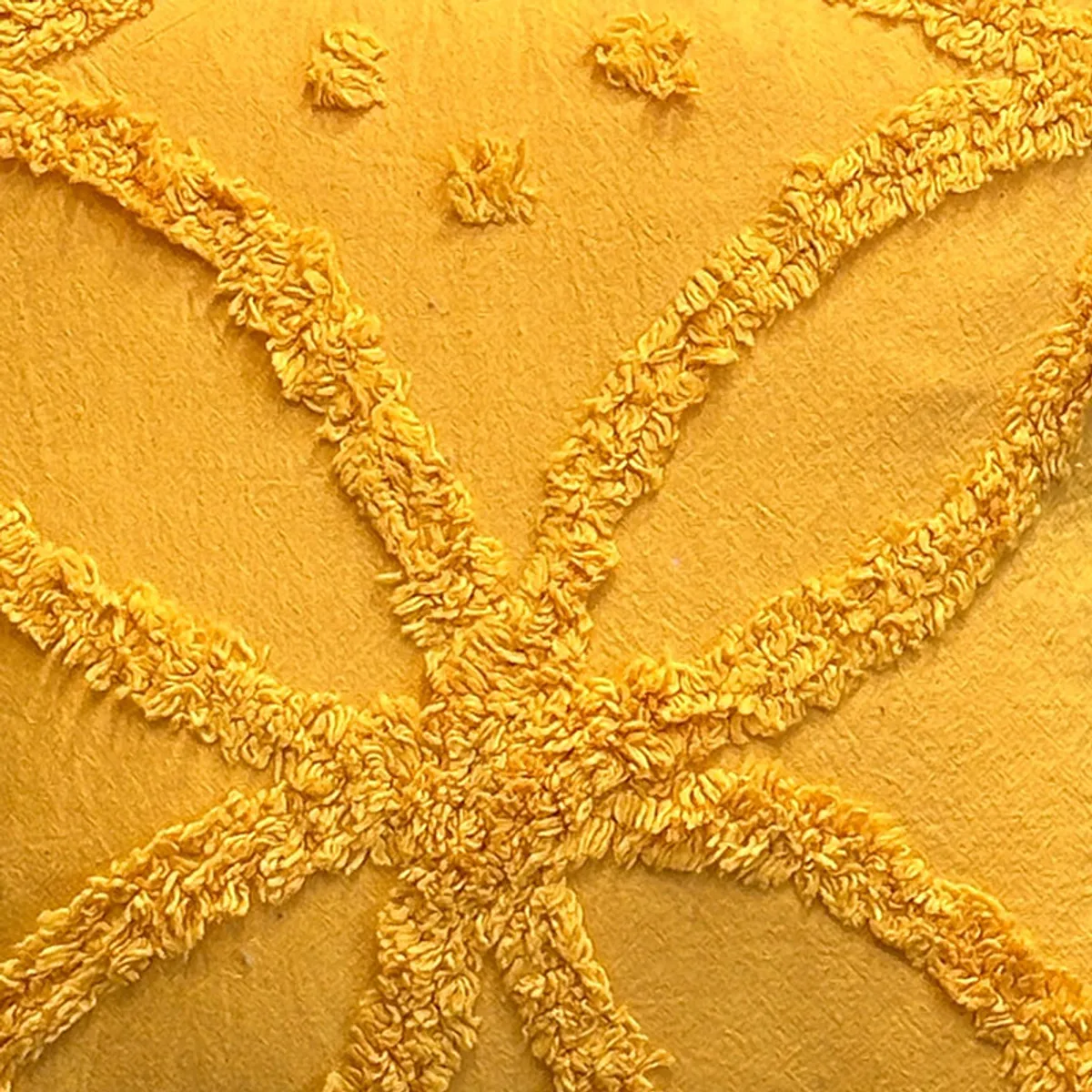 Close-up view of raised yellow tufted lines and textured surface