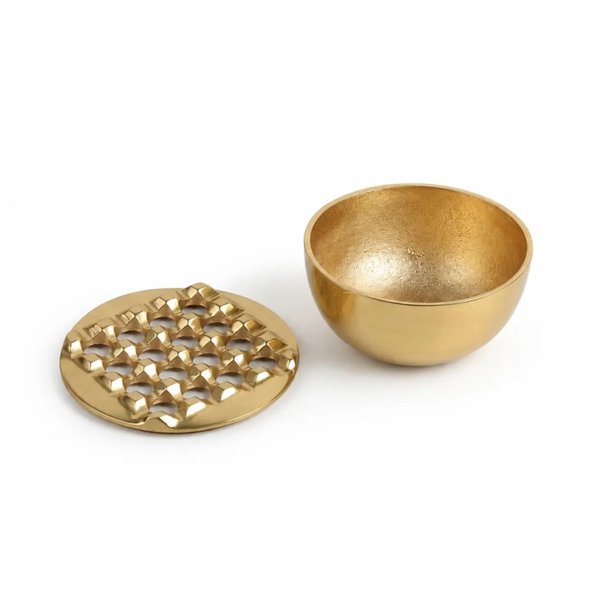 Gold ash tray shown open with its patterned top beside the bowl