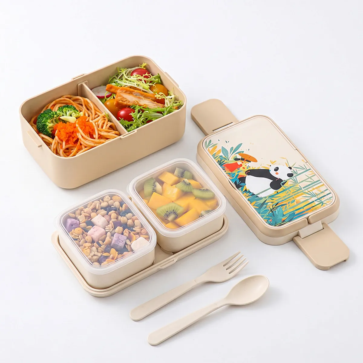 Open beige panda-print lunch box with separate food compartments, spoon and fork