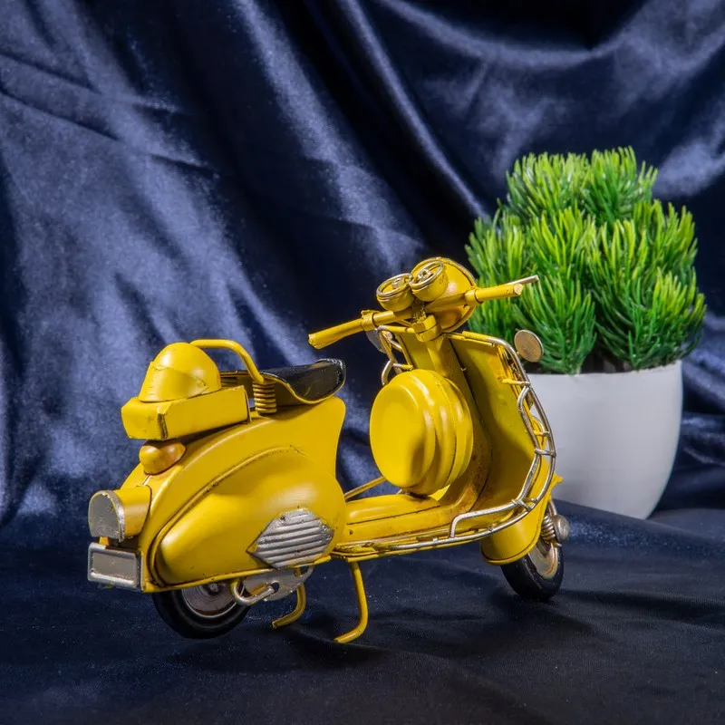 Rear angled view of yellow scooter showpiece with black seat