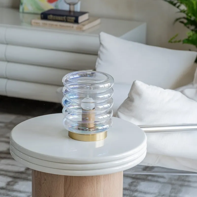 Bubble glass table lamp on a white round side table