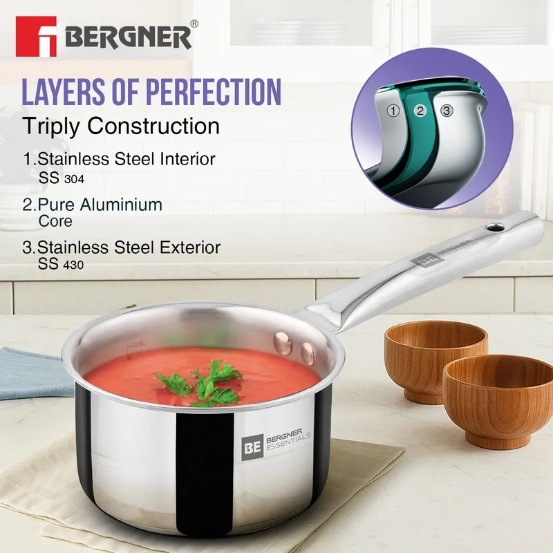 Silver saucepan with soup and a visible three-layer construction illustration.