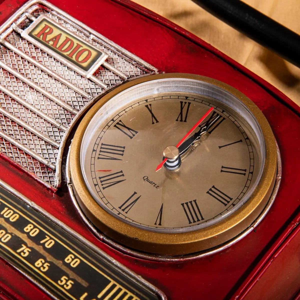 Close-up of round clock face set into the red radio-style showpiece