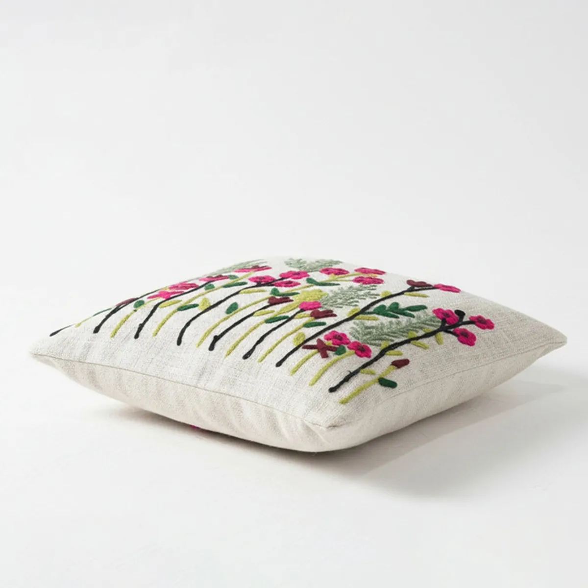 Square cushion cover shown flat with colourful floral embroidery on a white background.
