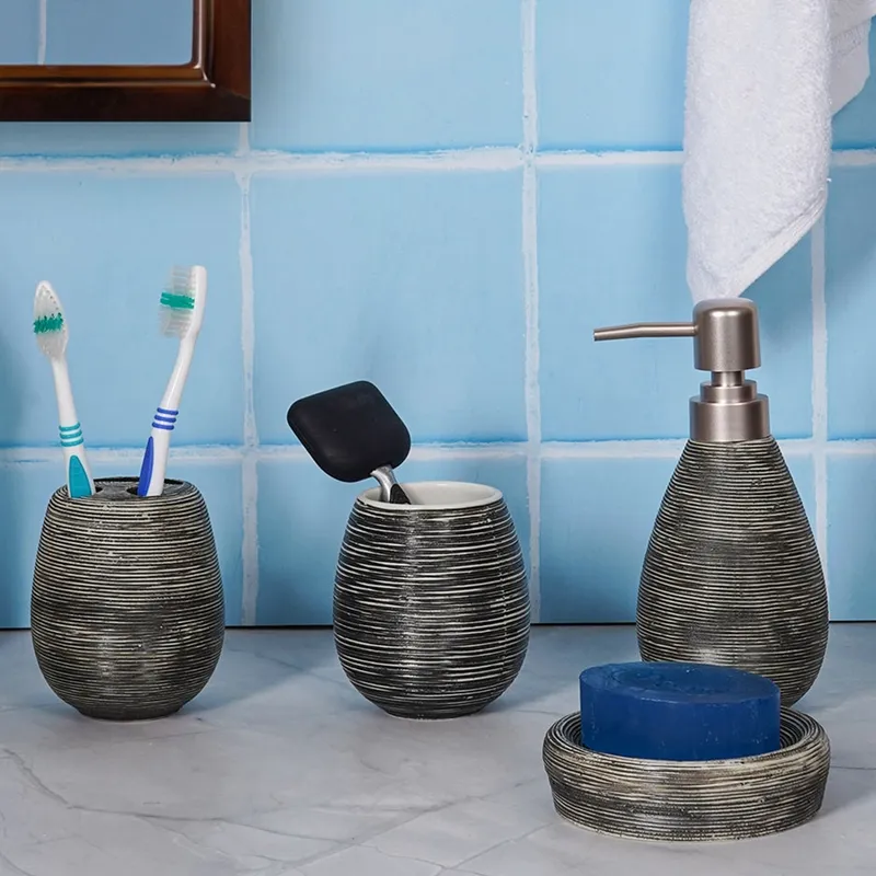 Black textured ceramic bathroom accessories arranged against blue bathroom tiles