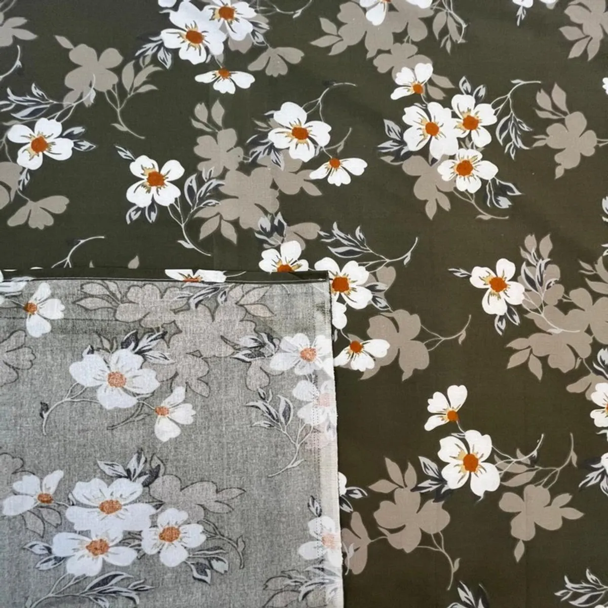 Green floral bedsheet showing the printed surface and matching reverse