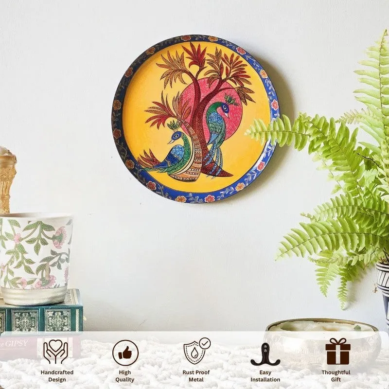 Round peacock wall plate mounted on a wall with decorative icons below