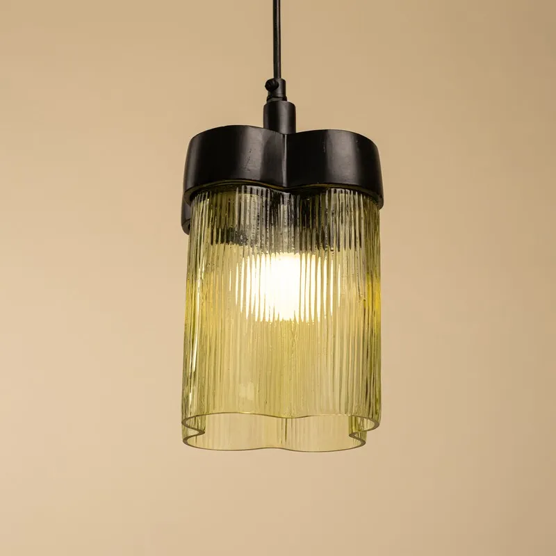 Lit green glass ceiling lamp with softly curved cylindrical form