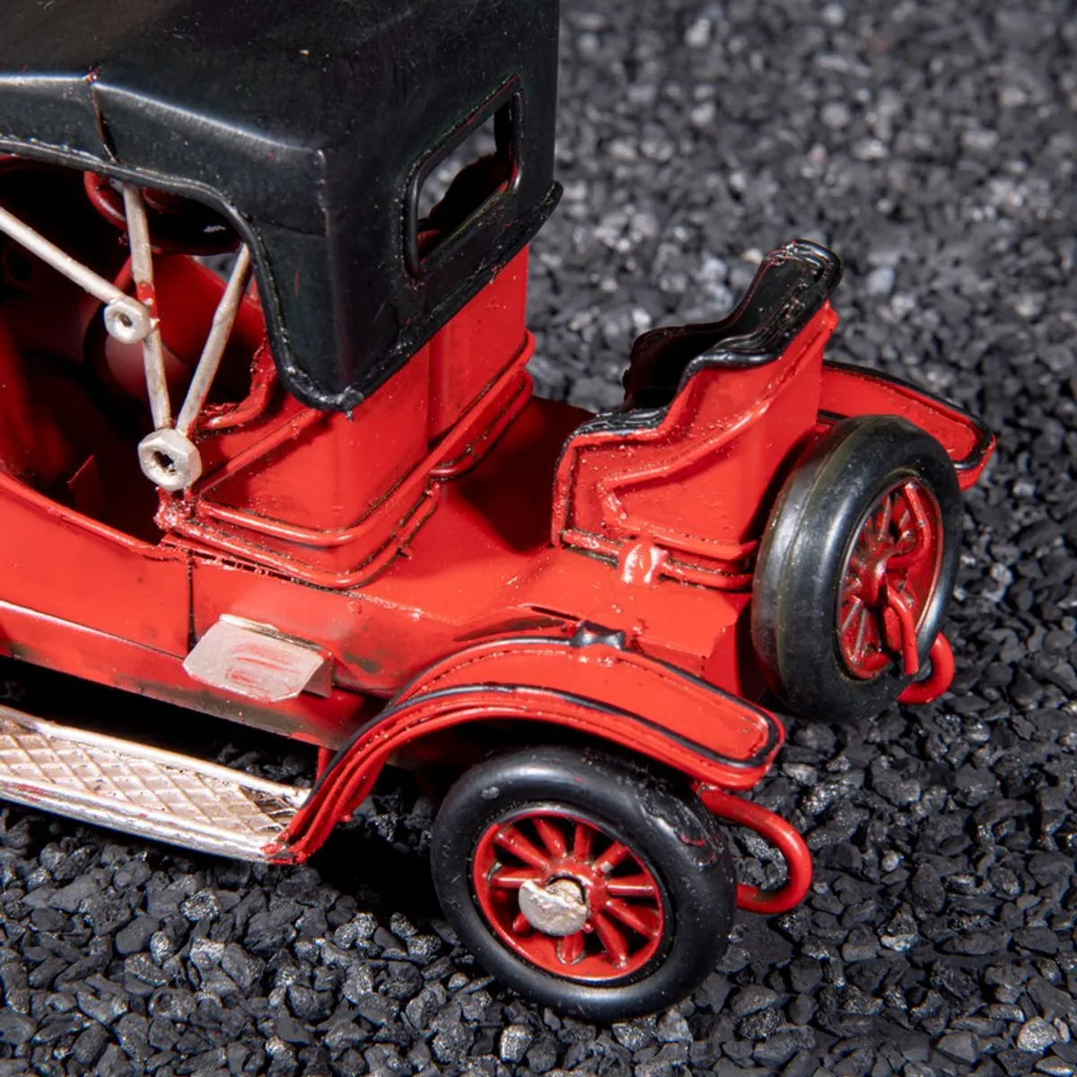 Close-up of the rear seat and wheel of the red car showpiece