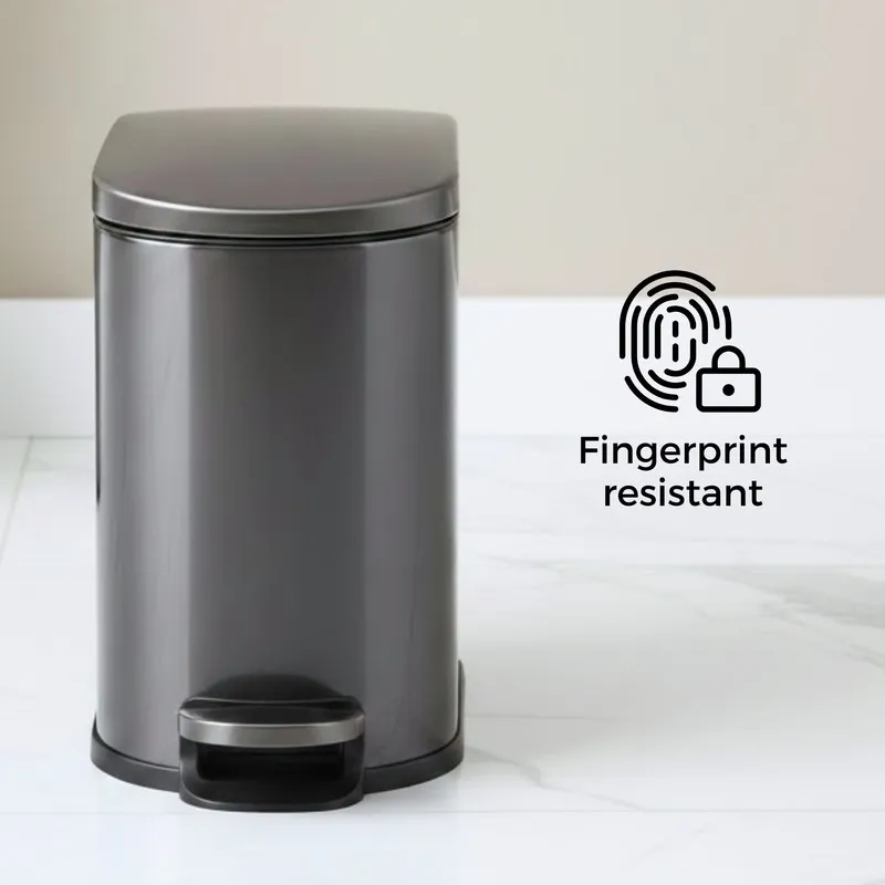 Front view of black metal pedal dustbin with closed lid