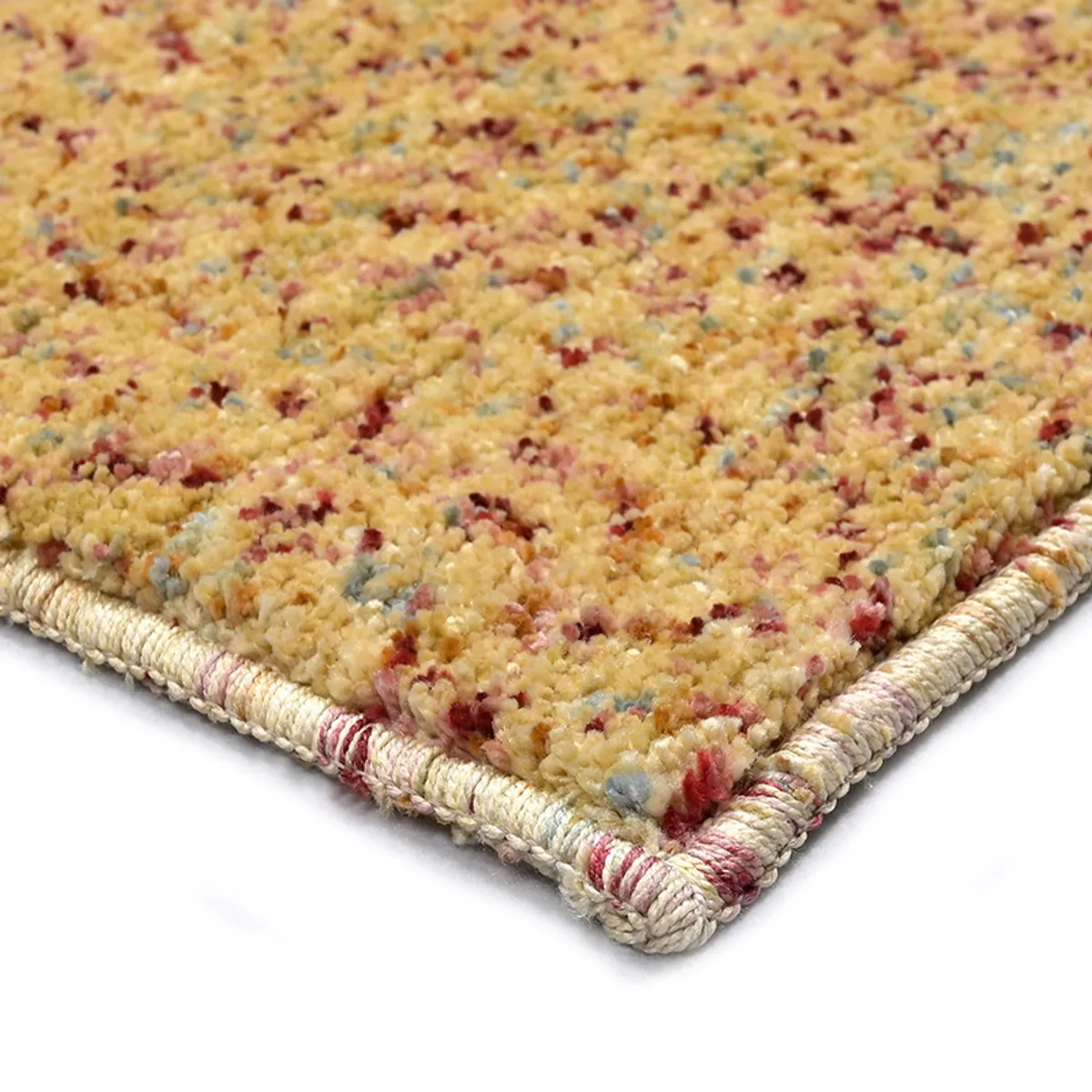 Close-up of the carpet's textured edge and yellow flecked surface