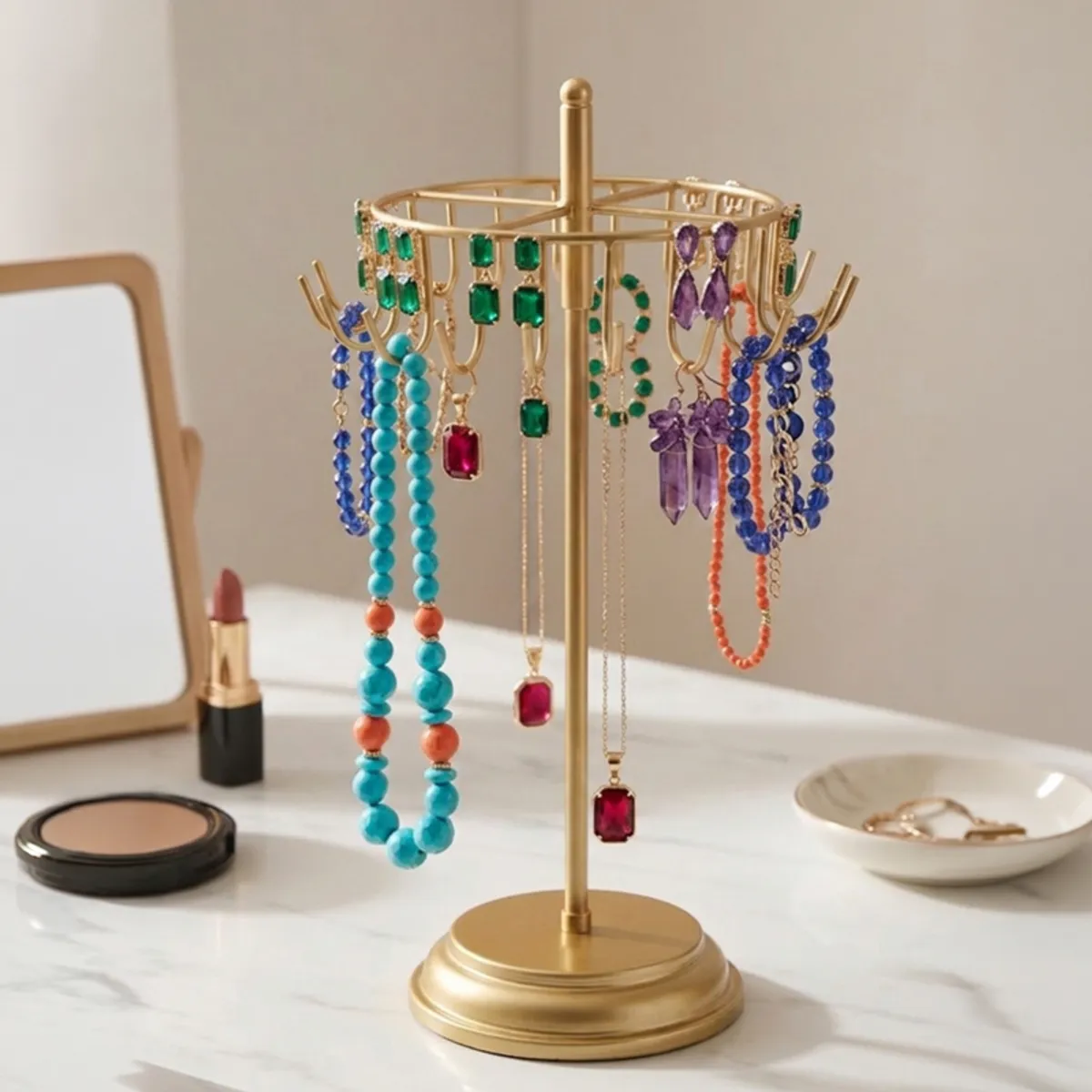 Gold jewellery stand displaying colourful necklaces, earrings and bracelets on a dressing table.