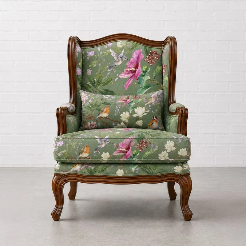 Front view of green upholstered lounge chair with floral bird pattern