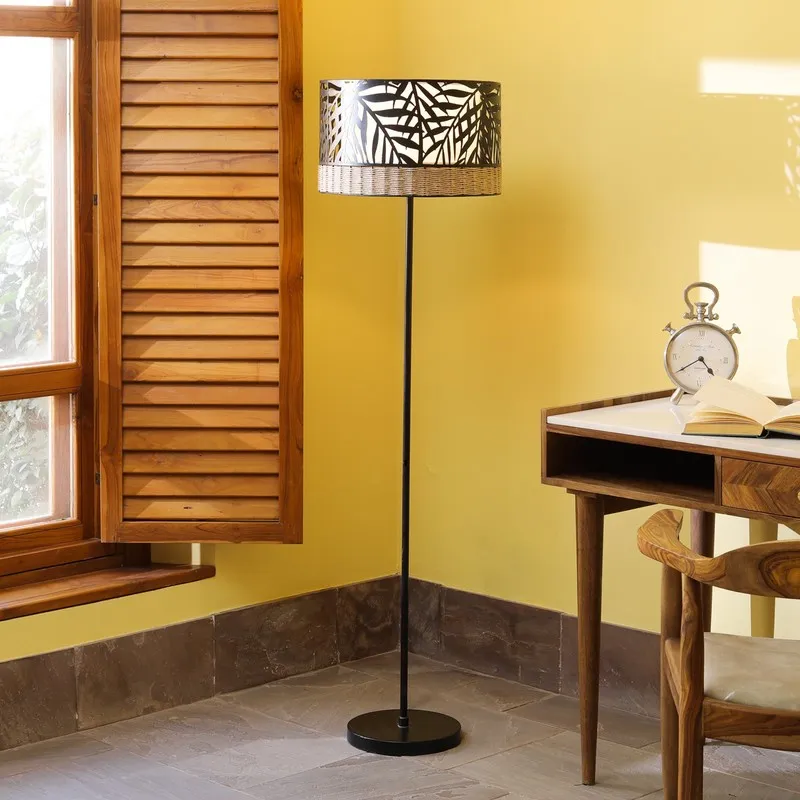 Freestanding black floor lamp with palm-pattern cylindrical shade