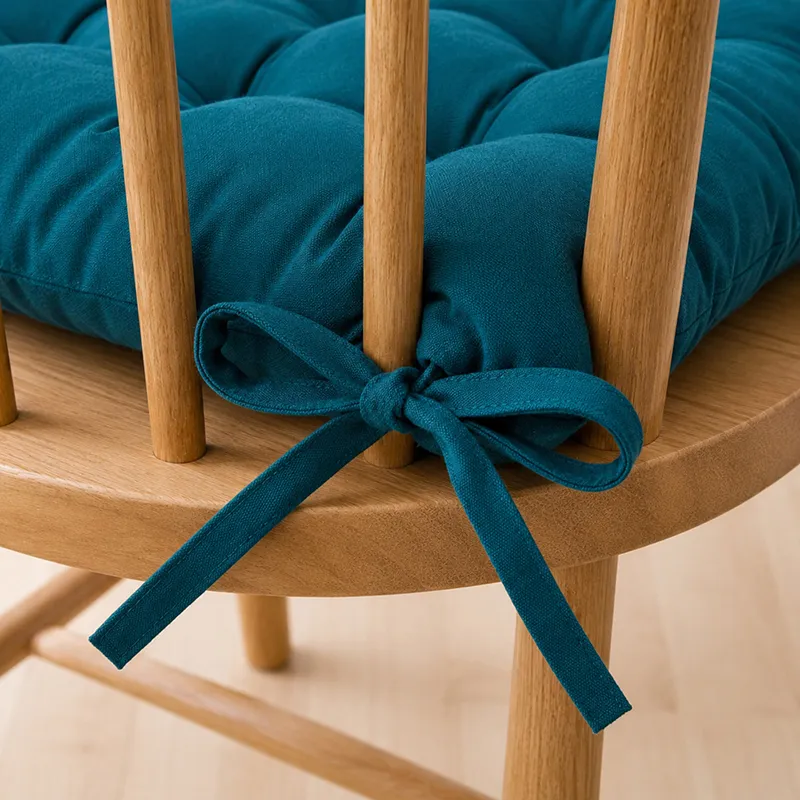Close-up of botanical green chair pad ties fastened to a wooden chair