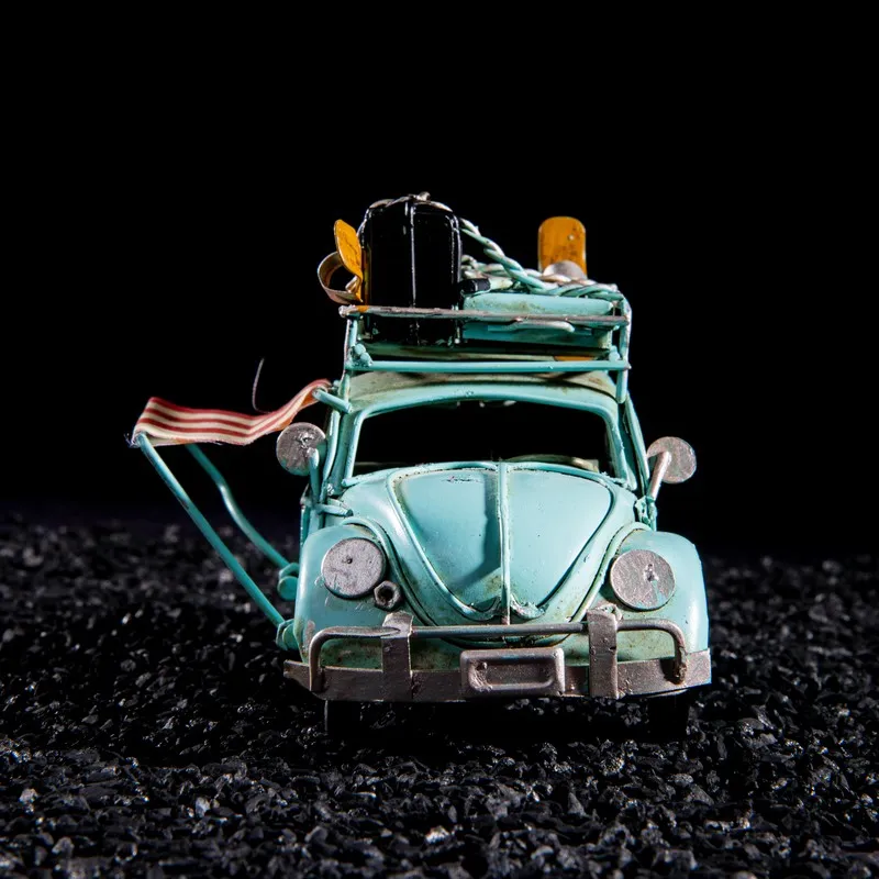 Front view of a blue retro beach car showpiece with rooftop beach accessories