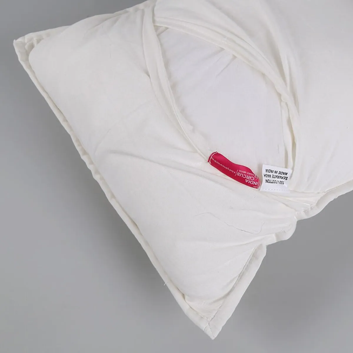 Close view of the white cushion cover reverse and flap detail