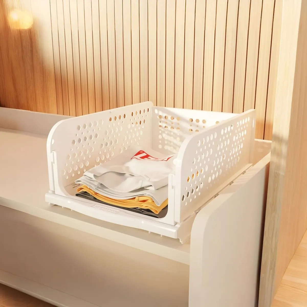 Single white organiser holding folded clothes on a shelf