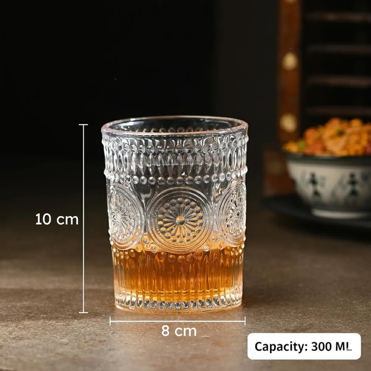 Clear textured whiskey glass with embossed pattern and amber drink