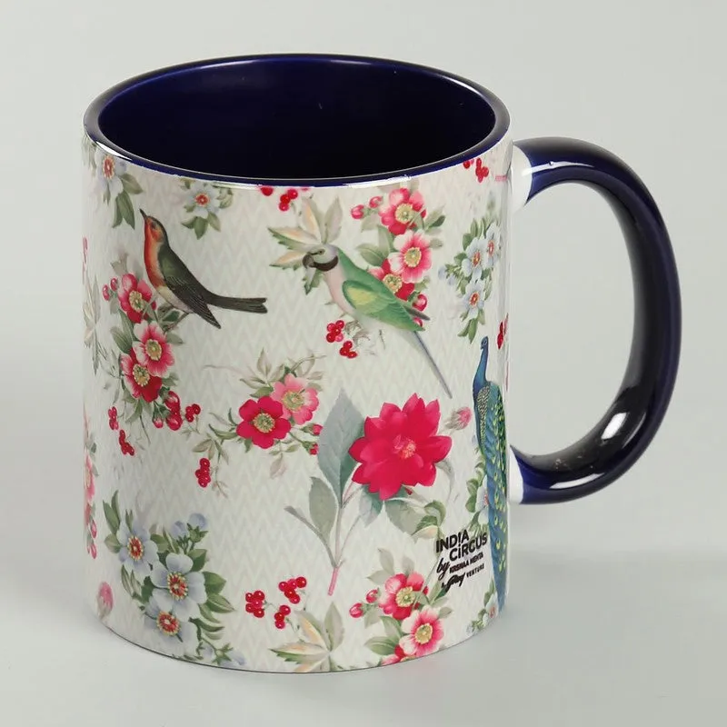Reverse view showing the floral bird design and dark blue handle